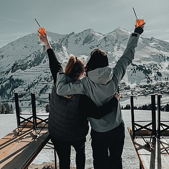 Paar genießt Aperol vor der Mankei Alm in Obertauern